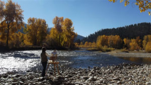 Roberta painting en Plein air at the river.